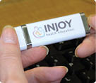 Closeup of hands holding an InJoy USB