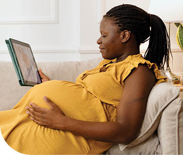 A woman is sitting on a couch, using a tablet computer. AI generated content